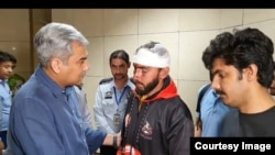 Pakistani Interior Minister Mohsin Naqvi meets students in Islamabad after they arrived from Bishkek on May 19.