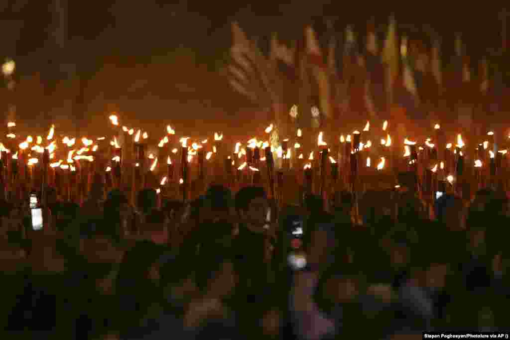 Thousands of Armenians participate in a torchlit procession in the nation's capital, Yerevan, on April 23. 
