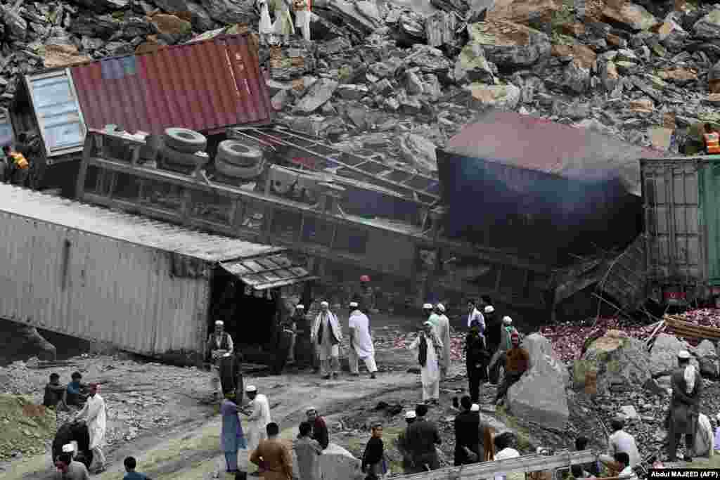 Rescuers work at the site of a landslide in northwestern Pakistan near the Torkham border crossing with Afghanistan on April 18. At least two people died in the incident as dozens of trucks that that were waiting to cross the border were buried under the rubble. Officials say the massive landslide was triggered by lightning amid heavy rains.