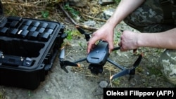 A Ukrainian soldier in Kherson prepares to operate a commercial DJI Mavic drone in June.