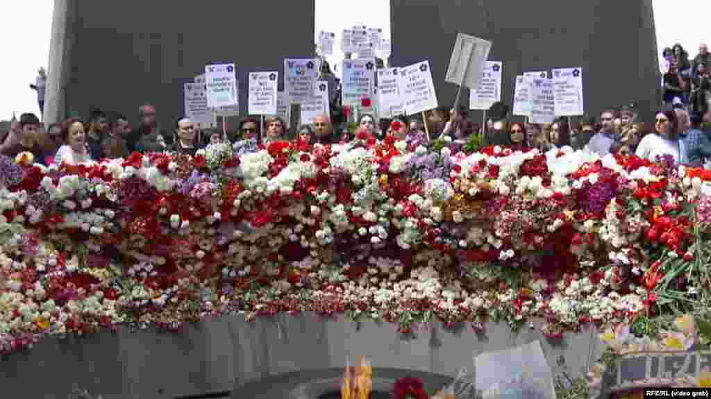 A video grab of the thousands of people who paid their respects, with many laying flowers at the Eternal Flame. 