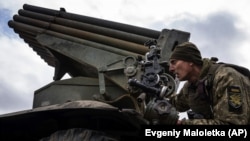 A Ukrainian paratrooper aims a Grad missile launcher at Russian positions near the front line in eastern Ukraine.