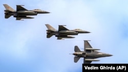 F-16 fighter jets of the Romanian Air Force perform a fly by at the Black Sea, Defense, Aerospace and Security (BSDA) international exhibition in Bucharest, Romania, May 22, 2024.