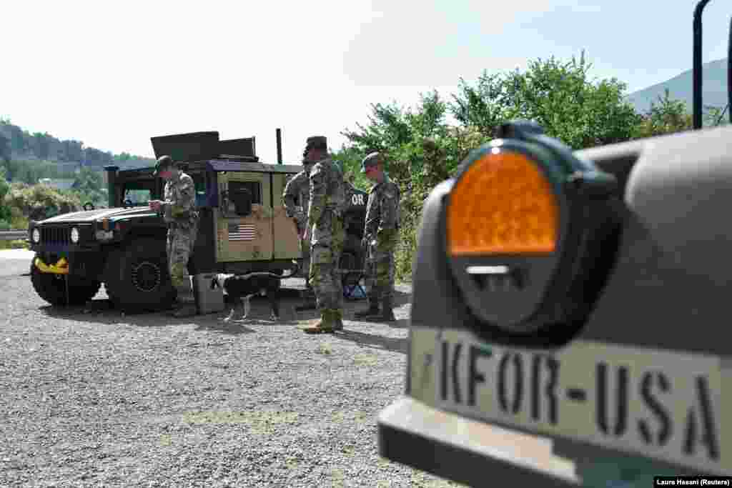 U.S. members of the NATO-led peacekeeping force stand near the border at Jarinje on September 1. Major General Ferenc Kajari, commander of NATO's peacekeeping mission in Kosovo, downplayed fears of violence over the reignited license issue, telling Reuters: "We don't see any kind of indication even of a preparation for a war.... Those who think responsibly, they should not talk about war.”