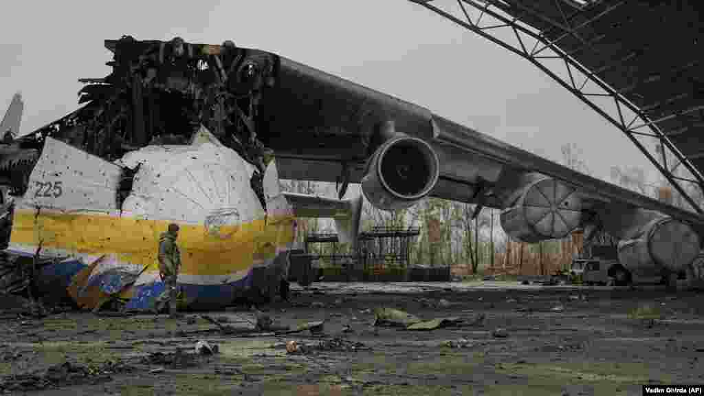 On April 2, a Ukrainian serviceman walks by the Antonov An-225 Mriya transport plane, which had been the world's largest aircraft. Ukrainian officials say it was destroyed by a Russian strike on February 27 during fighting at Antonov airport in Hostomel. The Mriya, which means "dream" or "inspiration," was beloved by aviation enthusiasts around the world.