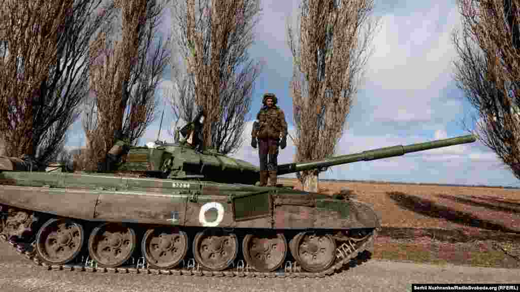 Український військовий стоїть на захопленому російському танку Т-72, який захопили українські військові в боях при звільнені села Лук‘янівка 