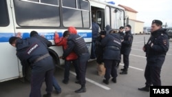 Russian police detain alleged illegal migrants during a raid at a Moscow market. The issue of migrants from Central Asia and the Caucasus is never far from the news.