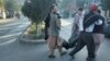 People carry a man wounded in the bombing in Kabul on September 30. 
