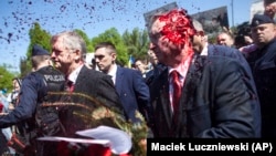 A video in May showed Russia's ambassador to Poland, Sergei Andreyev (right) being doused with red paint by participants of a protest against Russia's invasion of Ukraine during his attempt to lay flowers at a cemetery in Warsaw.