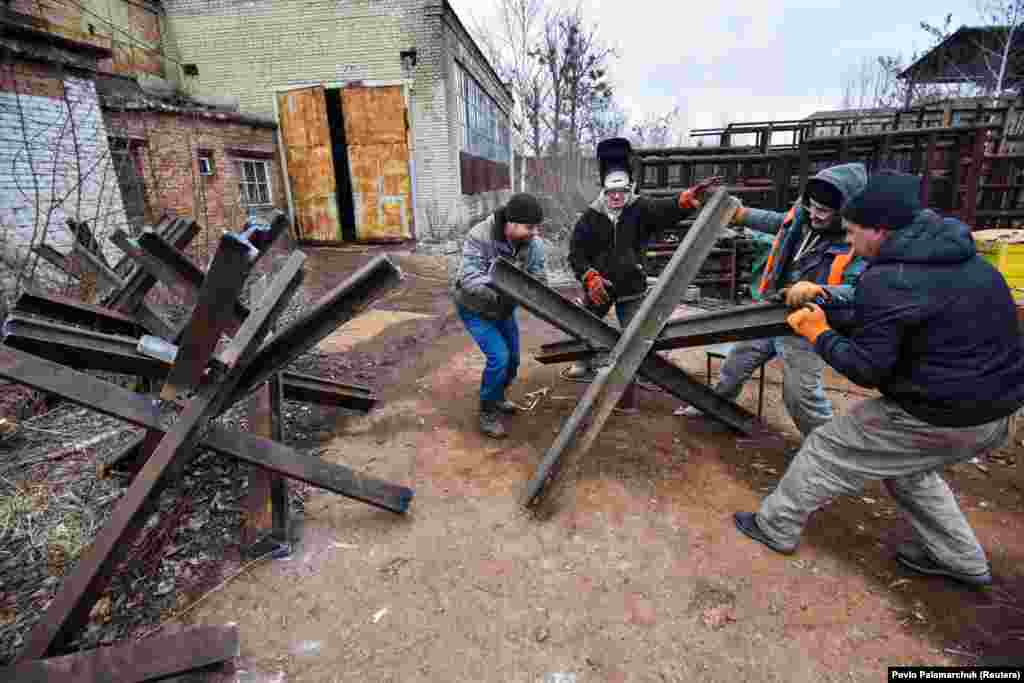 Locals from Lviv construct anti-tank obstacles in March. The “Czech hedgehog” tank barriers are favored for being easy to move on and off roads. They are also able to withstand explosions -- even if blasted into the air, the barriers bounce back to earth and remain effective. 