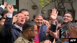 Police officials escort the Pakistan's former information minister Fawad Chaudhry (center) to present him before a court in Lahore on January 25, 2023.