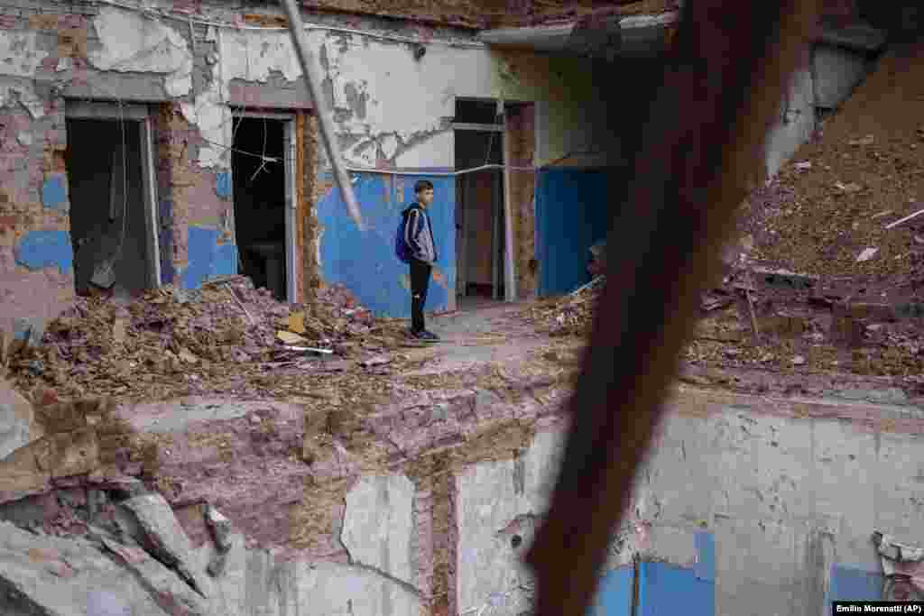 "When I'm at school, I think about the person who died in the debris. I feel deeply sorry for her," said Mykhaylo Kravchenko, 12, as he views a hole where his computer class once was.
