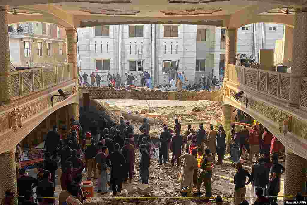 Eyewitnesses told RFE/RL's Radio Mashaal that suicide bombers standing in the first row behind the imam detonated explosive vests as worshipers, including many policemen and other officials, had gathered for afternoon prayers. 