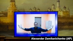 The late Russian opposition leader Aleksei Navalny appears on a TV screen during proceedings in a hearing of his appeal at a court in Moscow in January 2021.