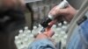 Сотрудник магазина во Львове отмечает российскую продукцию. 