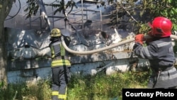 Firefighters extinguish a blaze at a logistics hub after a Russian missile strike on Odesa on June 20.