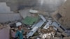 A man stands on the debris of a house at the site of a passenger plane crash in a residential area near an airport in Karachi on May 22.