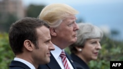 French President Emmanuel Macron, U.S. President Donald Trump, and British Prime Minister Theresa May (left to right) at the G7 summit in Sicily on May 26.