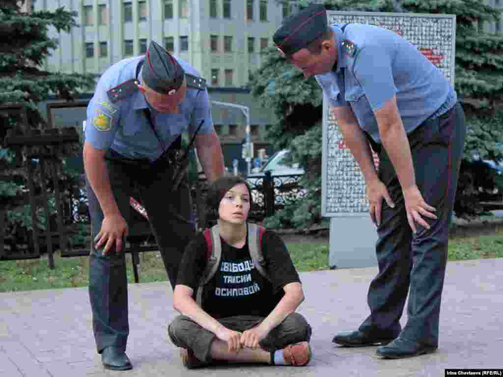 Police remove protesters from the Solovetsky Stone monument to victims of Soviet secret services in Moscow.