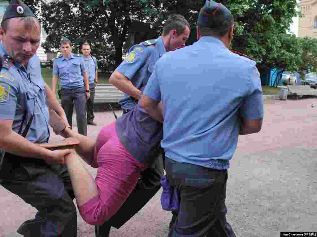 Police remove protesters from the Solovetsky Stone monument to victims of Soviet secret services in Moscow.