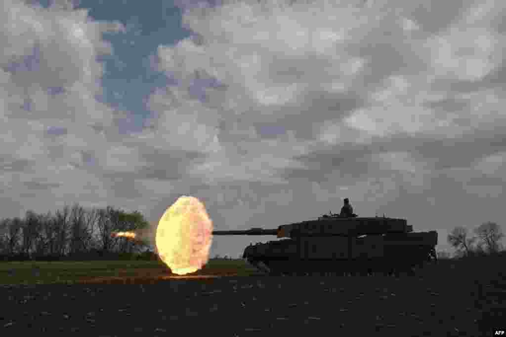 A Ukrainian tank crew fires a round from a Leopard 2A4 tank during a field training exercise at an undisclosed location.