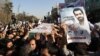 Mourners carry the coffin of Mostafa Ahmadi Roshan during his funeral in Tehran on January 13. Roshan is the fourth Iranian nuclear scientist to be assassinated in two years. Iran accuses Azerbaijan of colluding with Israel in the killings.
