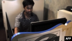 A computer user at an Internet cafe in Karachi, Pakistan on May 19.