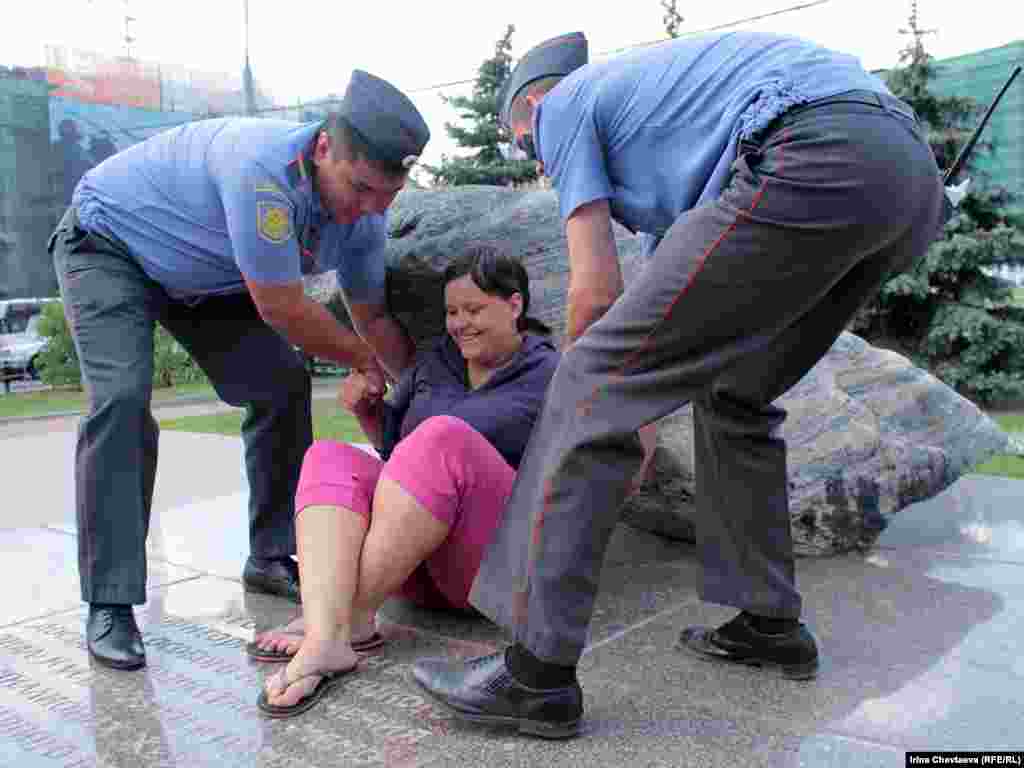 Police remove protesters from the Solovetsky Stone monument to victims of Soviet secret services in Moscow.