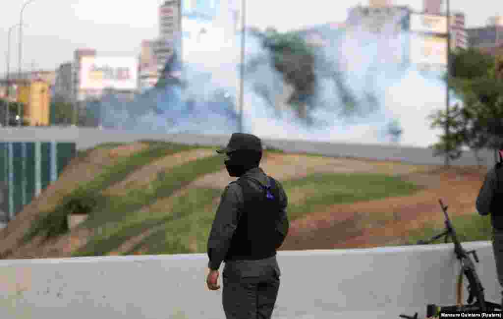 Tear gas floats in the air near the air base. 