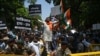 Protesters in New Delhi hold placards during a protest march towards the Pakistan High Commission condemning the Pahalgam attack on April 24. 