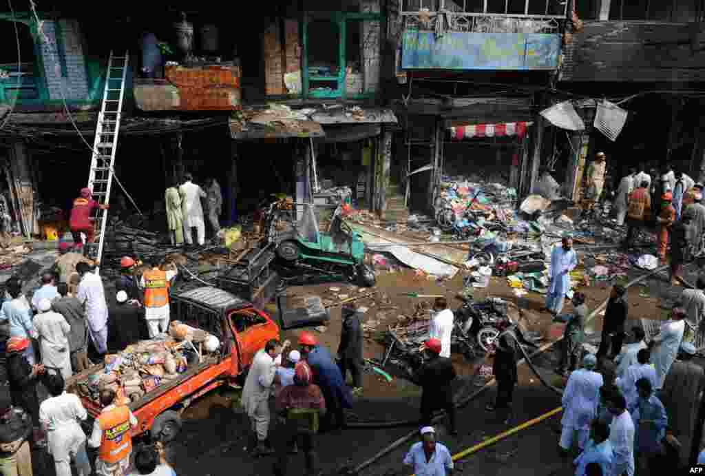 Security officials and rescue workers at the blast site.
