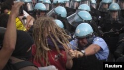 Policemen in riot gear clash with protesters outside the site of the NATO summit in Chicago on May 20. Scores of demonstrators were arrested.