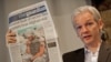 The Australian founder of the whistle-blowing website WikiLeaks, Julian Assange, holds up a copy of "The Guardian" at a press conference in London on July 26.