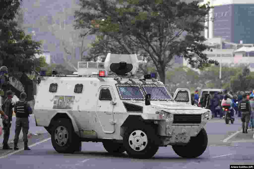 A military vehicle blocks an avenue next to the air base. 