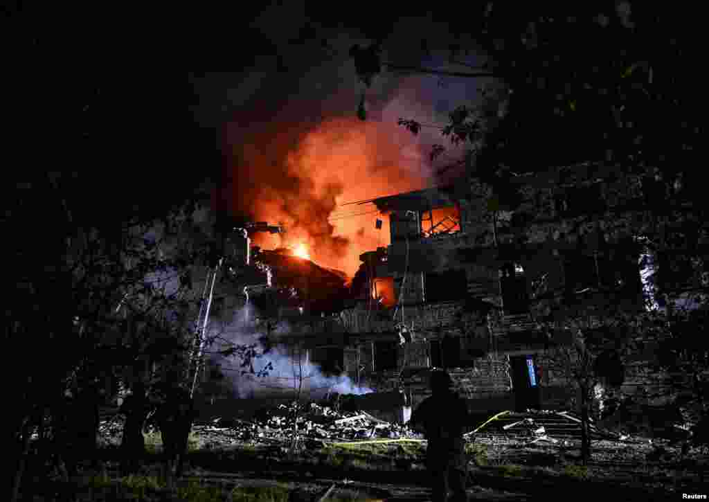 Ukrainian rescuers work at the site of an apartment building hit by a Russian drone strike in Zaporizhzhya on May 1.