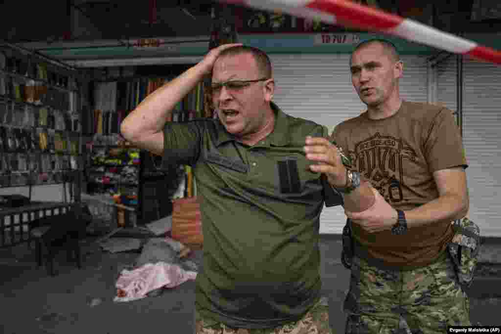 Ukrainian soldiers react after they recognize the lifeless body of their friend Artem Pohorelets. 