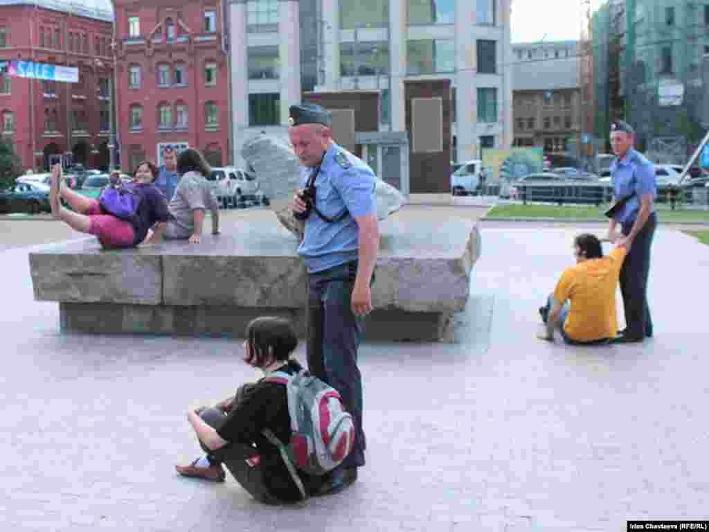 Police remove protesters from the Solovetsky Stone monument to victims of Soviet secret services in Moscow.