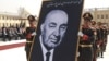 Army officers carry a portrait of late Afghan President Sardar Muhammad Daud during his funeral in Kabul in March 2009.