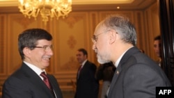Iranian Foreign Minister Ali Akbar Salehi (right) shakes hand with his Turkish counterpart Ahmet Davutoglu in Istanbul last month.