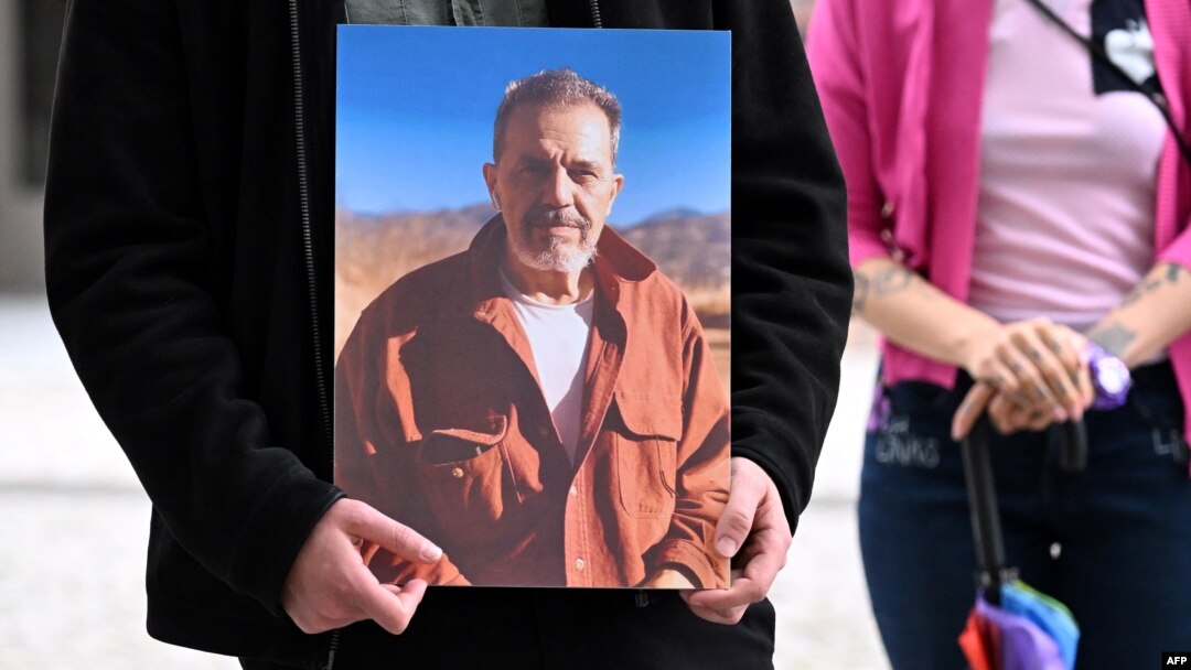 A protester outside Germany's Foreign Ministry holds a picture of Jamshid Sharmahd in July 2023. (file photo)