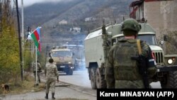 Azerbaijani military trucks are moving along the Lachin corridor near Nagorno-Karabakh in the presence of Russian peacekeepers deployed there as part of the Moscow-brokered 2020 ceasefire agreement between Azerbaijan and Armenia (file photo).