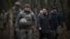 Ukrainian President Volodymyr Zelenskiy (second right) visits a division of the 27th Rocket Artillery Brigade on December 12. 