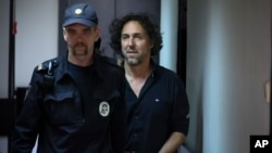 Laurent Vinatier (right) is escorted into a courtroom in Moscow on June 7.