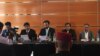 Brahamdagh Bugti (c) reading from a paper during a party meeting in Geneva on September 19.