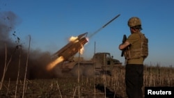 Ukrainian servicemen fire a Grad MLRS towards Russian troops near the frontline town of Pokrovsk