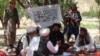 FILE: Taliban fighters militia talk with villagers on the outskirts of Gardez, the capital of Paktia province in southwestern Afghanistan.