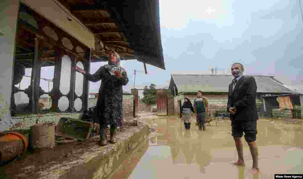 Residents of northern Iran show their flood-damaged home. 