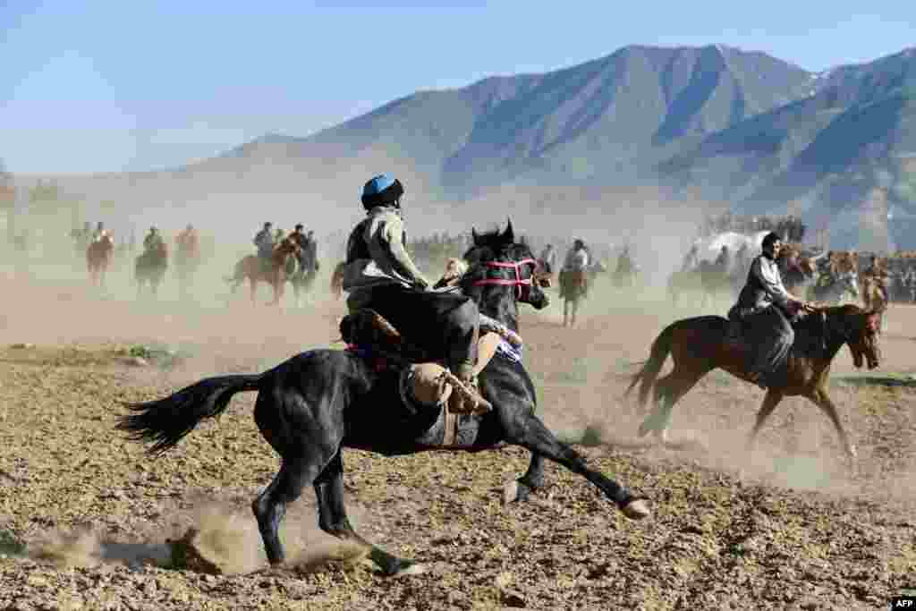 Afghan horse riders compete in a game of buzkashi in Badakhshan Province.