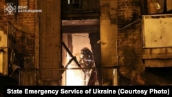 A Ukrainian firefighter works at the site of a Russian strike on Kharkiv late on May 2.