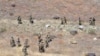FILE: Pakistani troops climb a hill in Ladha, a rural region in South Waziristan district.